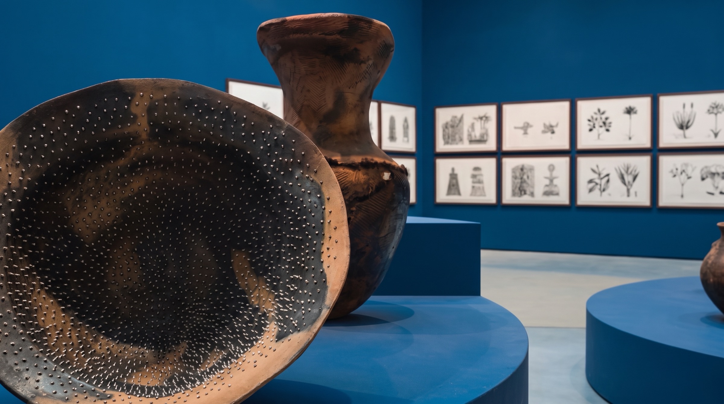 Adebunmi Gbadebo's Vessels of Ancestral Earth — Adebunmi Gbadebo with red clay vessels at Venice