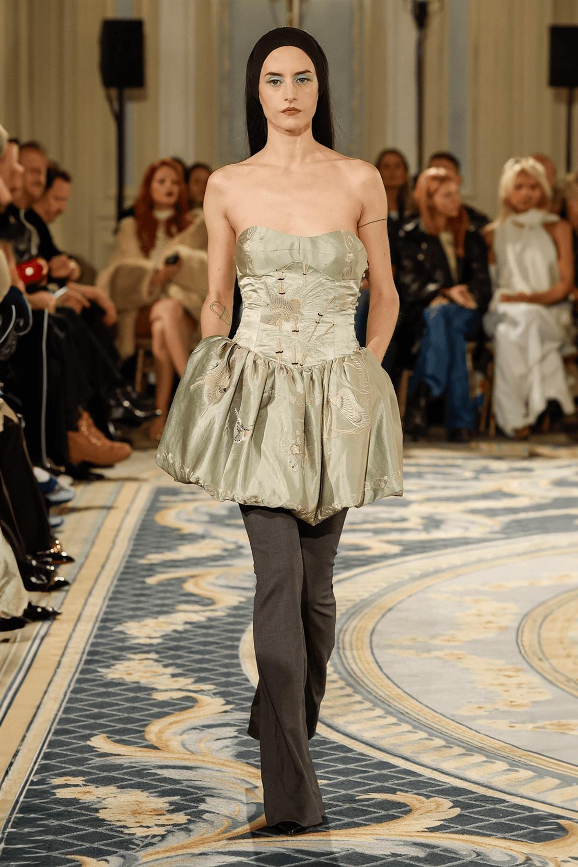 Conner Ives Autumn Winter 2024 runway look in a sculptural pale dress