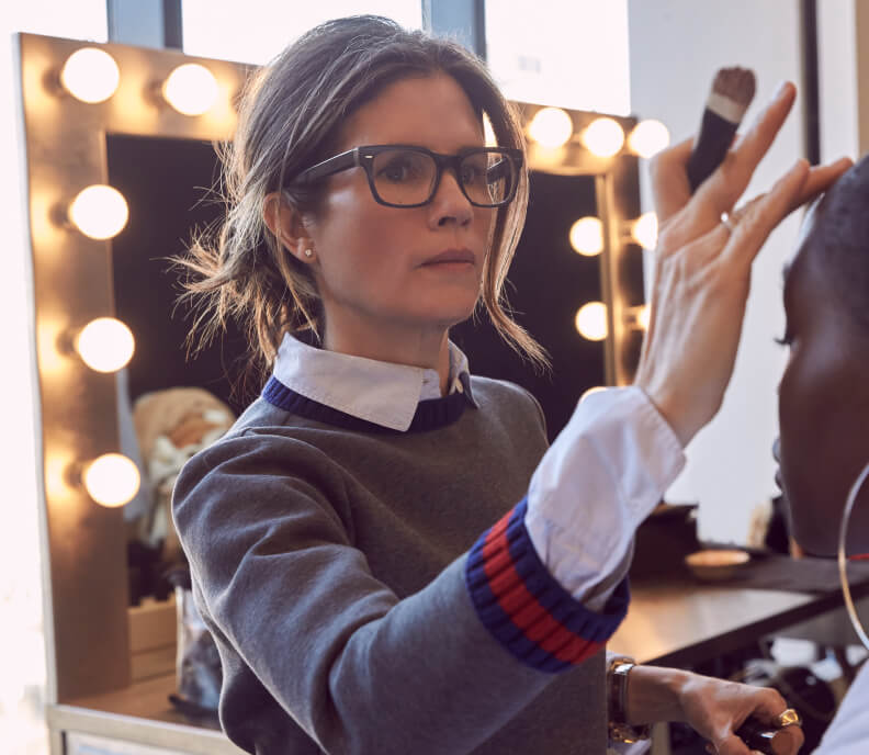 Gucci Westman applying makeup during a beauty shoot